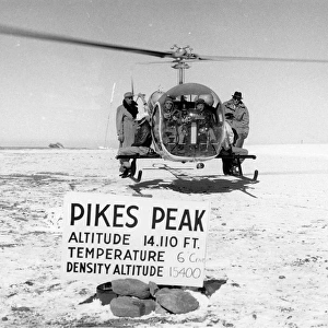 Bell Model 47G-3 hovers atop Pikes Peak with pilot and f?