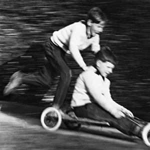 Two boys on a home-made go-kart