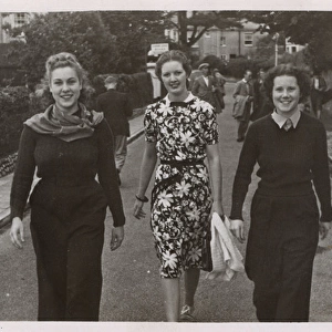 Candid Street snap - Three jolly young women walk down road
