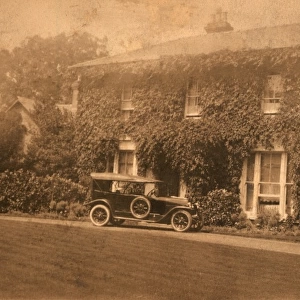 Car parked outside detached house with ivy