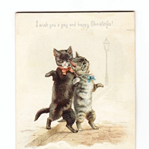 Two cats dancing on a movable Christmas card