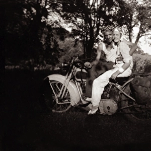 Couple sitting on their 1948 Harley Davidson motorcycle