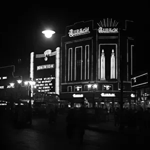 Dominion Theatre and Burton store at night, London