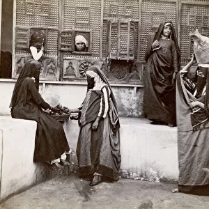 Egypt; interior of a courtyard, veiled women and children
