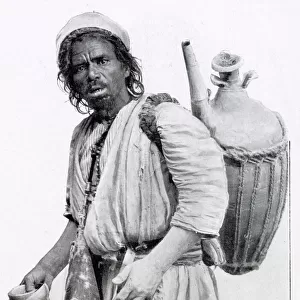 Egyptian man selling water from a clay jug on his back in Cairo, Egypt
