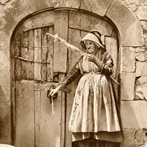 Elderly woman with distaff and spindle, Auvergne, France