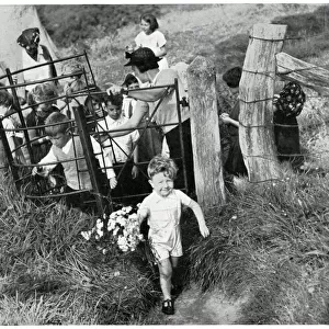 Evacuee children walking through countryside gate, Sept 1939