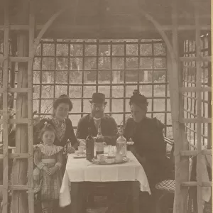 A family, three adults and a little girl, sitting in a rustic