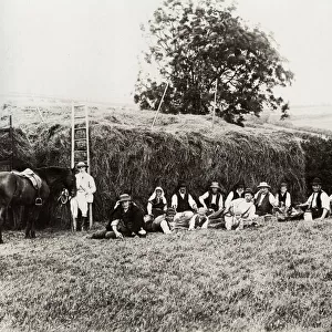 Farm workers resting beside a haystack, Somerset