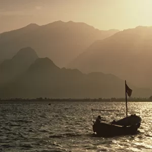 Fishing boat with a backdrop of Taurus mountains, Antalya