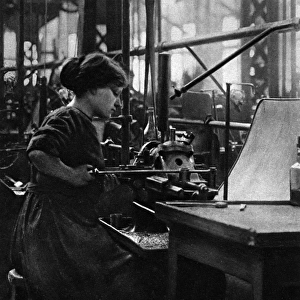 French woman in a munitions factory, making parts for arti