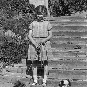 Girl with three dogs in a garden