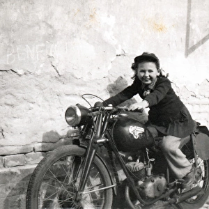 Girl sat on a veteran motorcycle