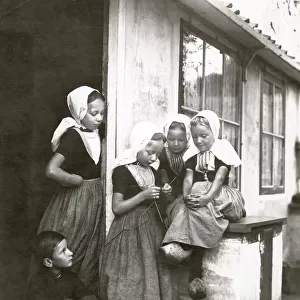 A group of Dutch fisherchildren, four girls and a boy, wearing traditional costumes