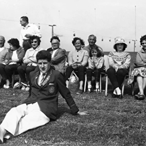 Holidaymakers and a Redcoat at Butlins holiday camp