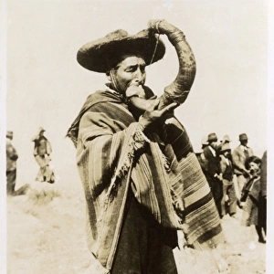 Indian blowing a trumpet made ​​of horn
