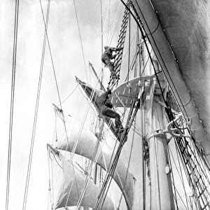 Man climbing rigging of sailing ship