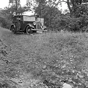 Man in a field with parked car
