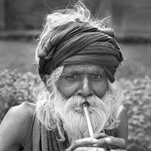 Man playing tin whistle, Agra, India - 2