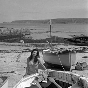 Model on a beach with fishing boats