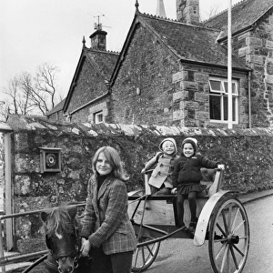 Mother taking children to school in pony and trap, Cornwall