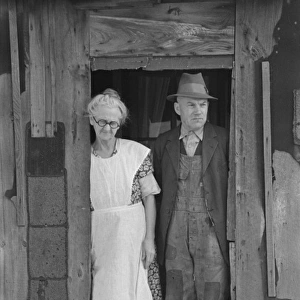 Mr. and Mrs. John Landers, tenant farmers, at the backdoor o