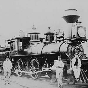 An old fashioned steam train and workers