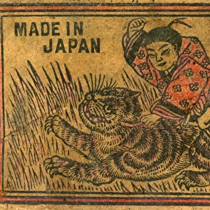Old Japanese Matchbox label with a man fighting a tiger