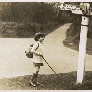 Petworth - Young boy checking his directions on a signpost
