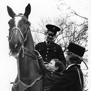 Police officer on horseback, WPC and little boy, London