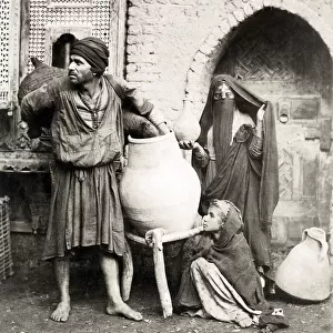 Porter, water carrier, woman, child in Cairo Egypt