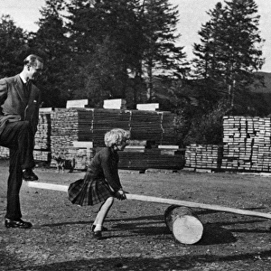 Queen Elizabeth IIs children on a see-saw, 1957