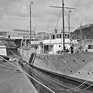 Scene in a harbour with steamship in foreground