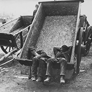 Sleeping workmen in a cart