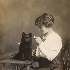 Studio portrait, woman with Pomeranian dog