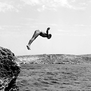 Swimmer diving into the sea off the coast of Malta