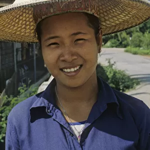 Woman in Bangkok wearing traditional Thai hat, or ngob