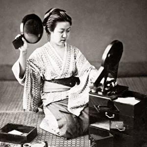 Woman doing her hair with two mirrors, Japan, circa 1880s. Date: circa 1880s