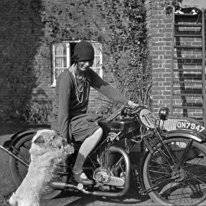 Woman on a motorbike with a dog