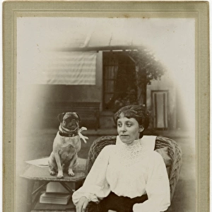 Woman with a pug dog in a garden