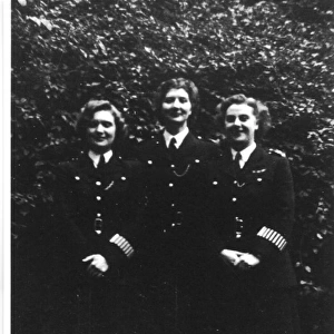 Three women police officers in a garden