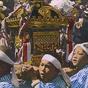 Young boys carrying a Mikoshi - portable Shinto Shrine