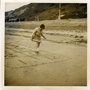 Young Girl Playing Hopscotch on the Beach, Boscombe, Hampshi