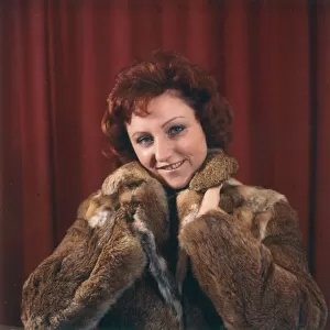 Young woman in a fur coat