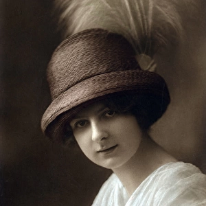 Young woman in hat with feather
