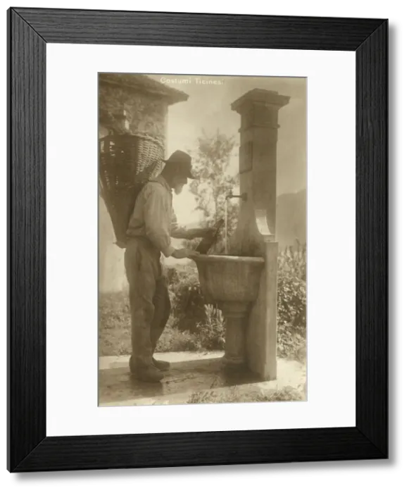 Framed Print : A Man of Ticino re-fills his water bottle - Switzerland Framed Print : A Man of Ticino re-fills his water bottle - Switzerland