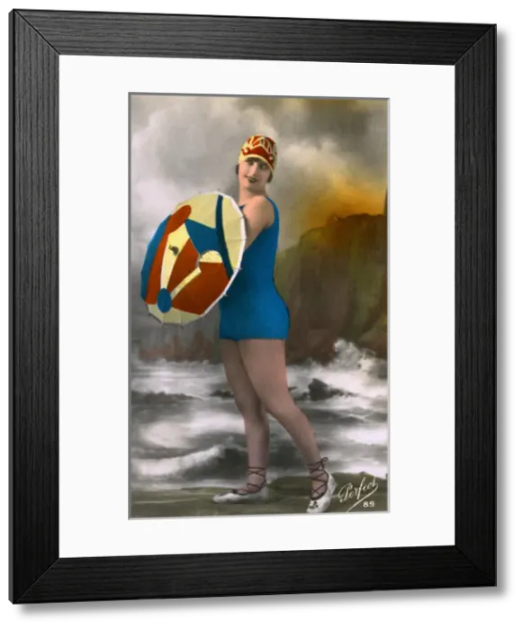 Framed Print : French girl in swimwear, carrying a colouful parasol Framed Print : French girl in swimwear, carrying a colouful parasol