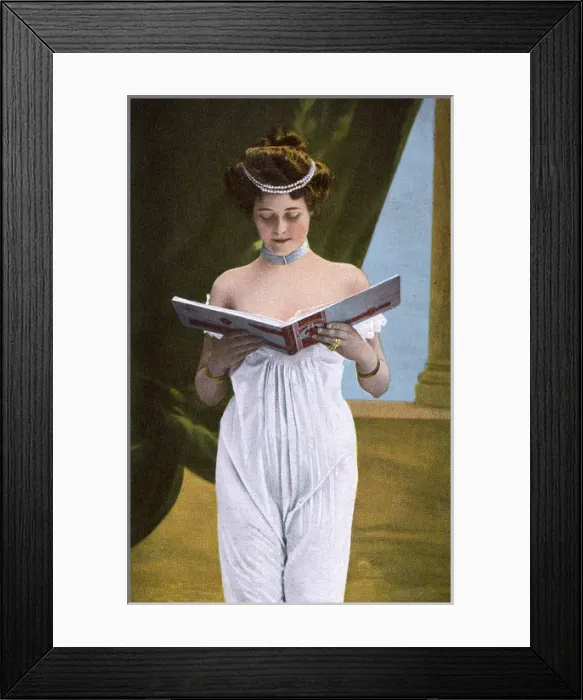 Framed Print : Pretty girl in white dress looking through photograph album Framed Print : Pretty girl in white dress looking through photograph album