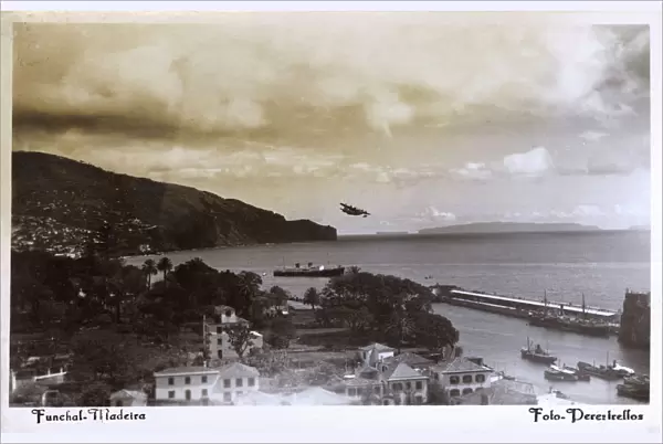 Coastal view of Funchal, Madeira with seaplane taking off