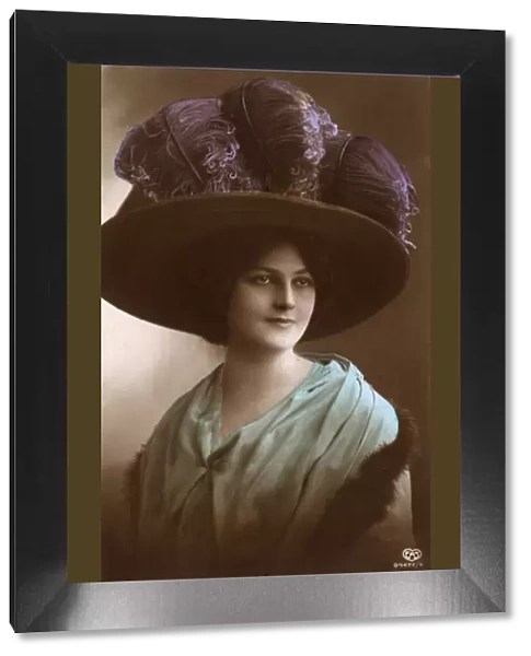 Lady wearing a large hat with Ostrich Feathers